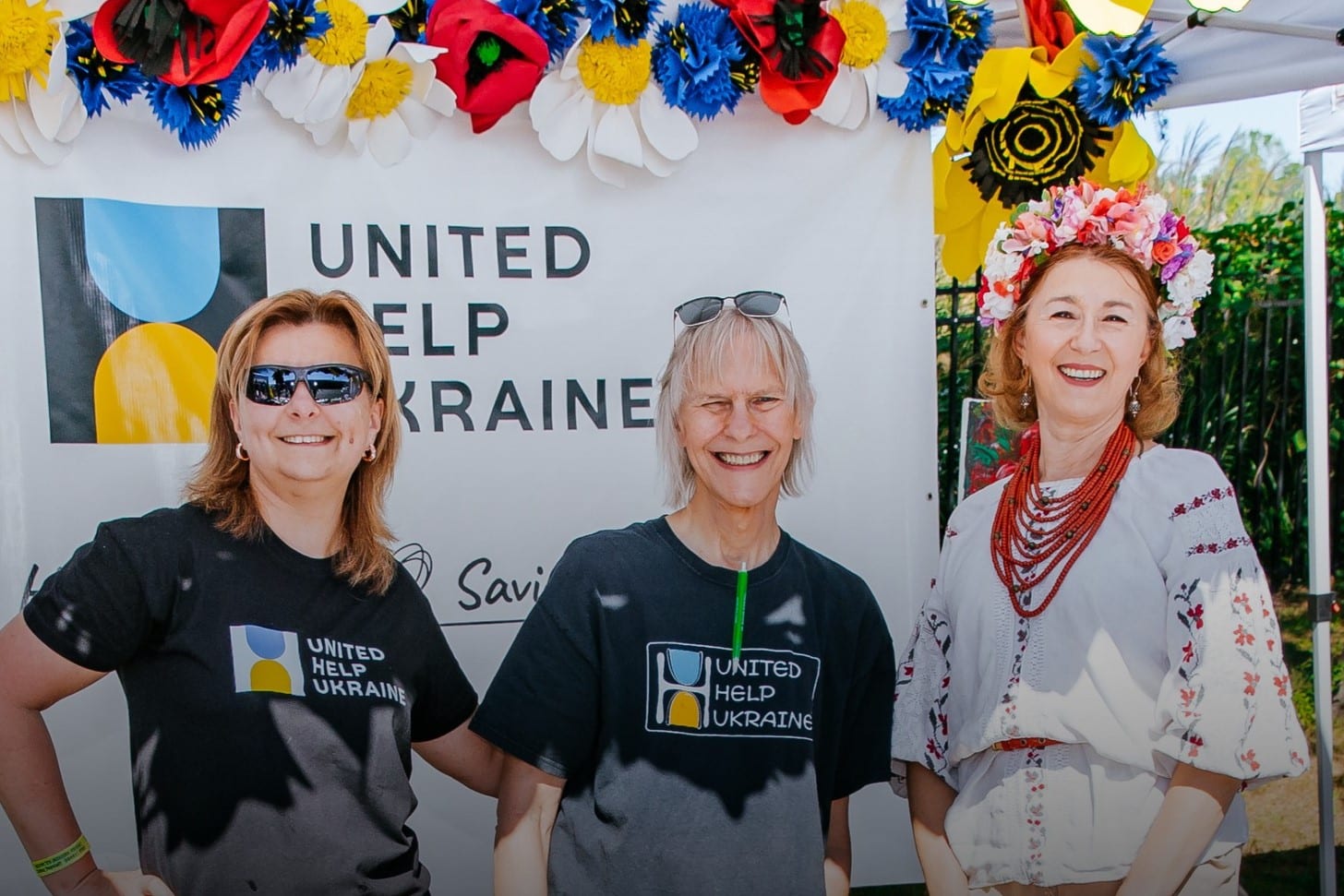 Civilians HELP Team of two ladies waering CVH t-shirts and one lady in Ukrainian national costume during the Ukrainian Food and Culture Festival in Philadelphia