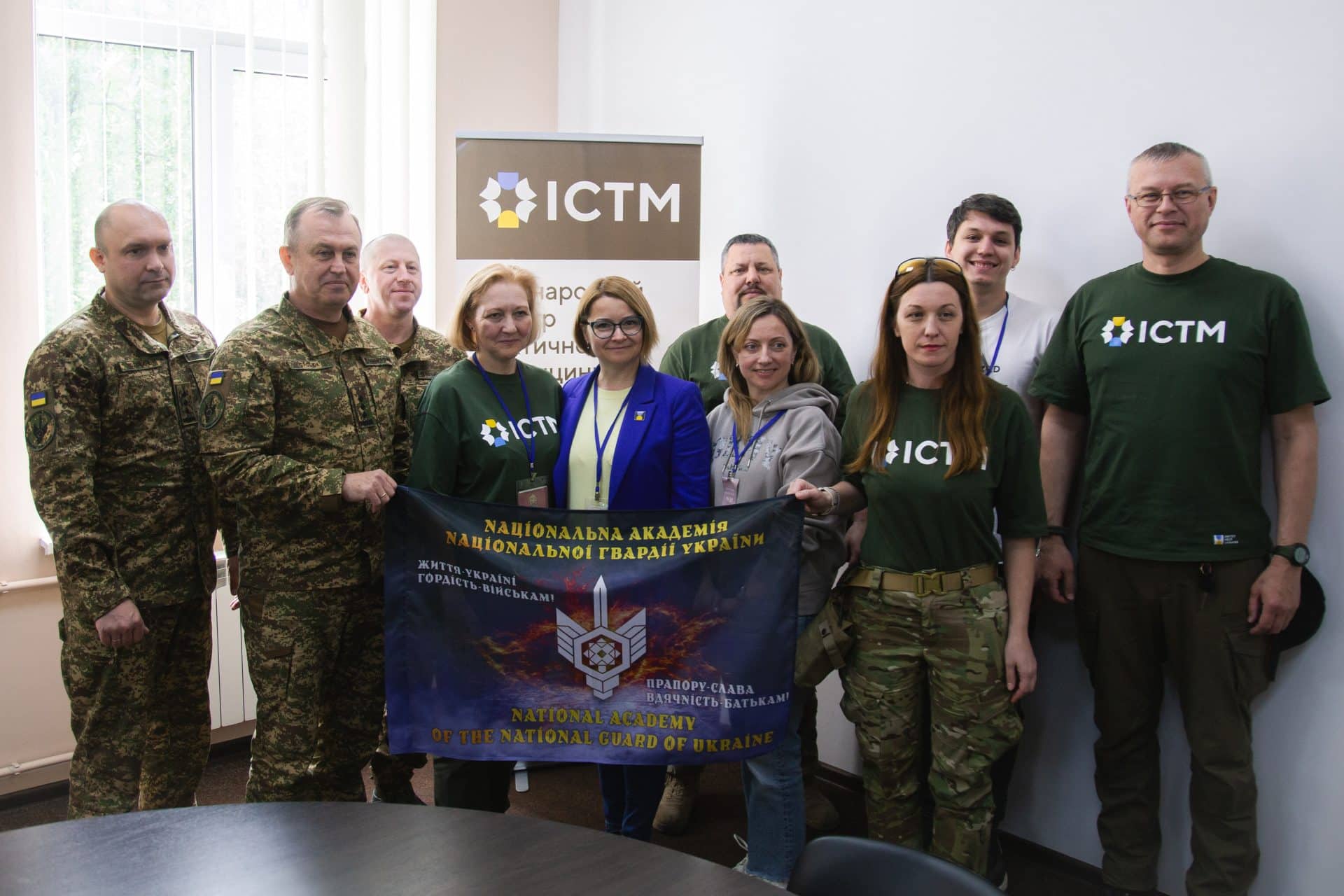 A team of Tactical Medicine Training for Defenders in Lviv with ICTM banner behind them.