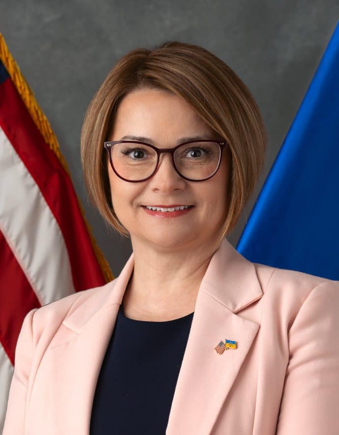 Photo of Civilians HELP President, Dr. Maryna Baydyuk wearing black and rose outfit.